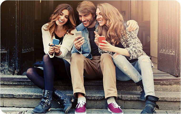 Friends sitting using their phone